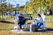 Image of man and woman sitting outside on chairs